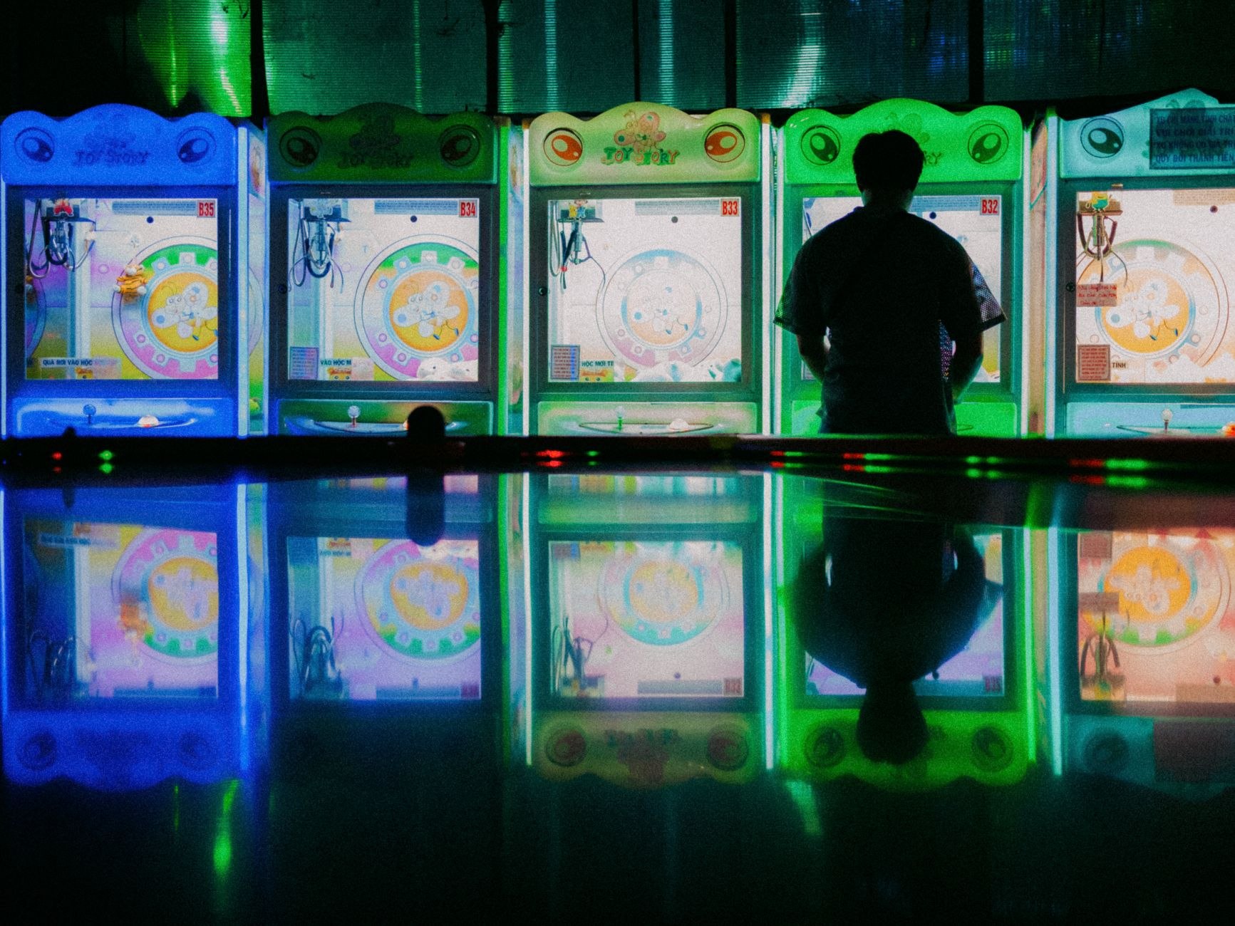 Person holding a phone in a ferry terminal waiting lounge, viewing the Terminal Nights game interface